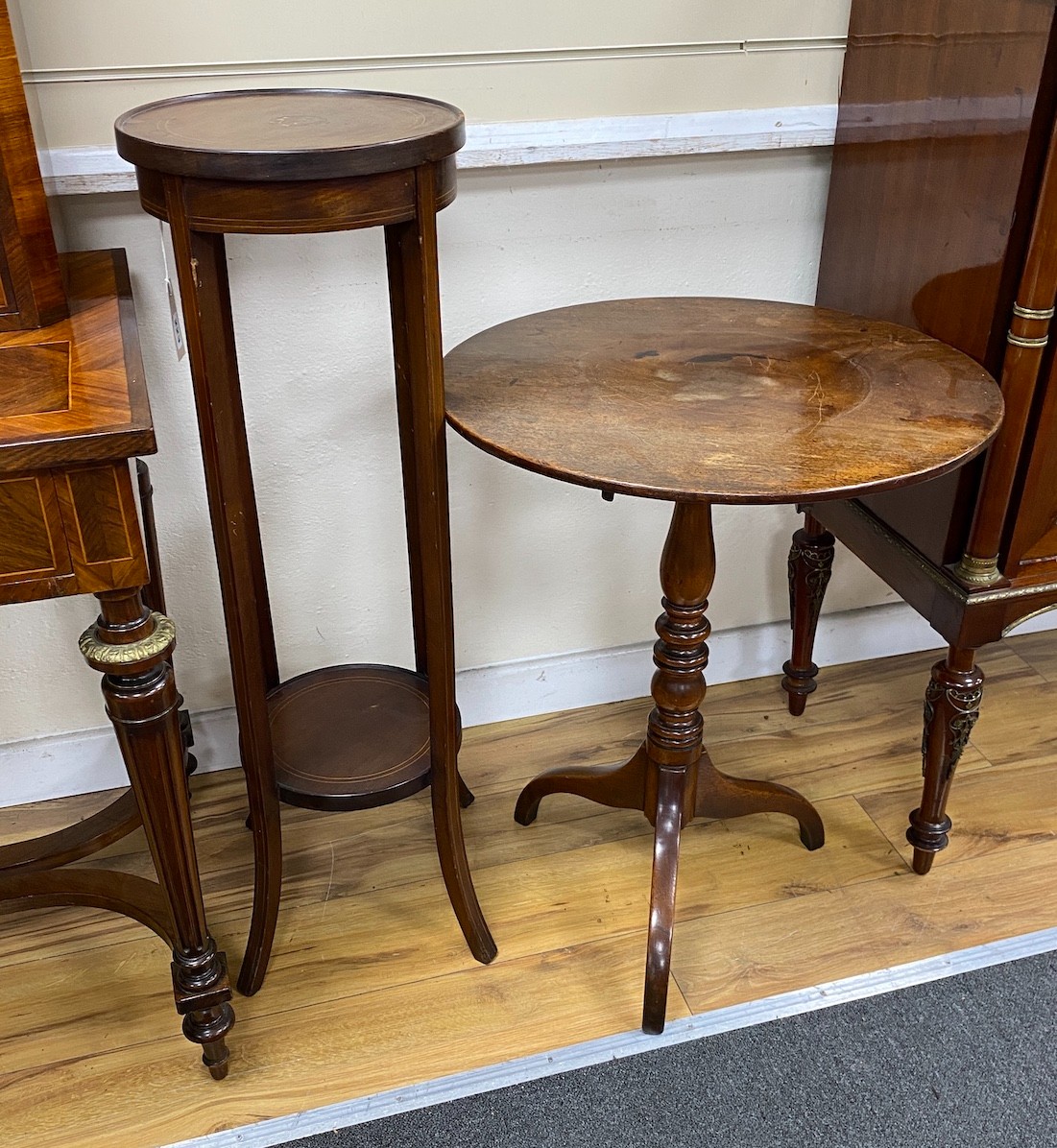 A George III mahogany circular tripod tea table, diameter 56cm, height 69cm together with a mahogany two tier plant stand